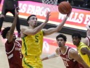 Oregon guard Chris Duarte (5) shoots in front of Stanford forwards Ziaire Williams (3) and Jaiden Delaire (11) during the first half of an NCAA college basketball game in Stanford, Calif., Thursday, Feb. 25, 2021.