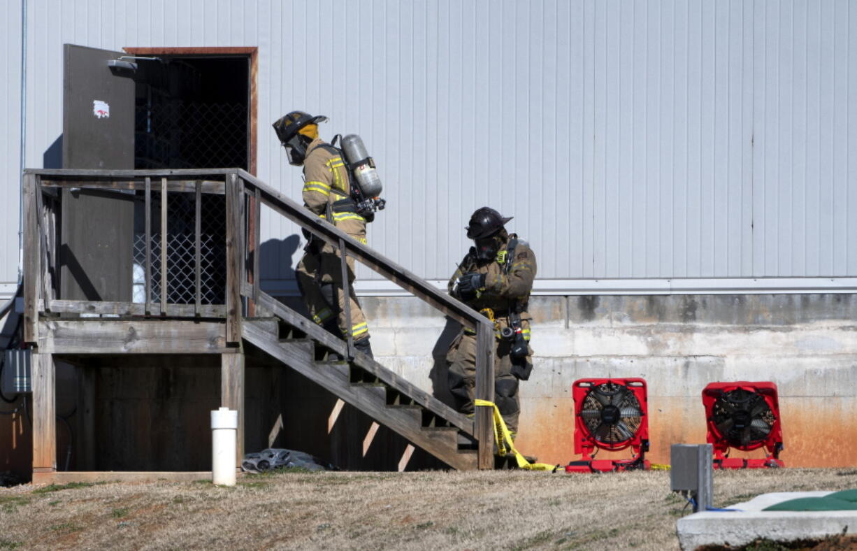 Two Hall County Firefighters enter a back door Friday, Jan. 29, 2021, at Foundation Food Group in Gainesville, Ga., the day after six people were killed following a liquid nitrogen leak at the plant.