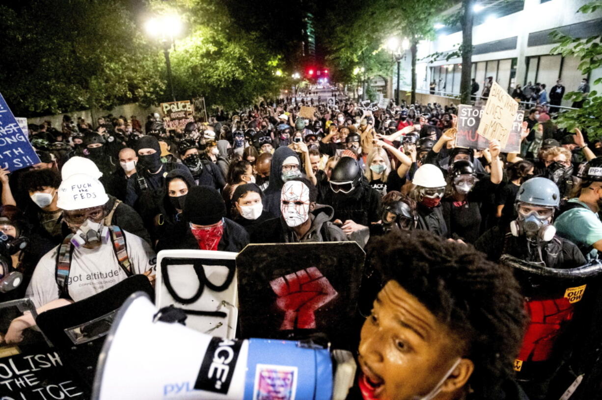 FILE - In this Aug. 2, 2020, file photo, Black Lives Matter protesters march through Portland, Ore. after rallying at the Mark O. Hatfield United States Courthouse. A lawmaker in Oregon is trying to repeal a statute that allows police to declare an unlawful assembly, which critics say enables authorities to restrict free speech and the right to assemble.