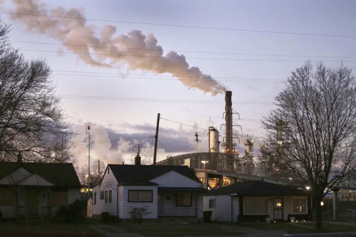 In an undated file photo, smoke billows from a Marathon Petroleum refinery near a neighborhood in southwest Detroit. The Donors of Color, a philanthropic group dedicated to pushing for racial equity in funding environmental projects nationwide, has launched a pledge drive challenging the nation&#039;s top climate funders to shift 30% of their donations toward environmental efforts led by Black, Indigenous and other people of color.