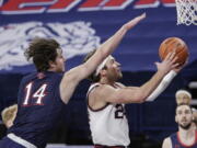 Gonzaga forward Corey Kispert, right, shoots in front of Saint Mary&#039;s forward Kyle Bowen during the first half of an NCAA college basketball game in Spokane, Wash., Thursday, Feb. 18, 2021.