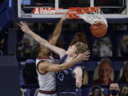 Gonzaga guard Aaron Cook, left, dunks over San Diego forward Ben Pyle during the second half of an NCAA college basketball game in Spokane, Wash., Saturday, Feb. 20, 2021.