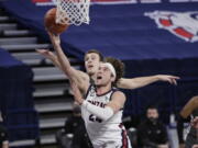 Gonzaga forward Corey Kispert, front, shoots in front of Santa Clara forward Josip Vrankic during the second half of an NCAA college basketball game in Spokane, Wash., Thursday, Feb. 25, 2021.