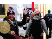 A photo included in federal charging documents shows Battle Ground resident Jeffrey Grace, 61, in the background of a photo of a man carrying U.S. House Speaker Nancy Pelosi's lectern during the Jan. 6 riot at the U.S. Capitol. Grace was arrested by federal authorities Thursday on suspicion of one count of unauthorized entering or remaining in any restricted building or grounds. (U.S.