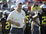 FILE - Oregon head coach Mario Cristobal watches during warm ups before the Rose Bowl NCAA college football game against Wisconsin, in Pasadena, Calif., in this Wednesday, Jan. 1, 2020, file photo. The National Signing Day period begins Wednesday, Feb. 3, 2021.