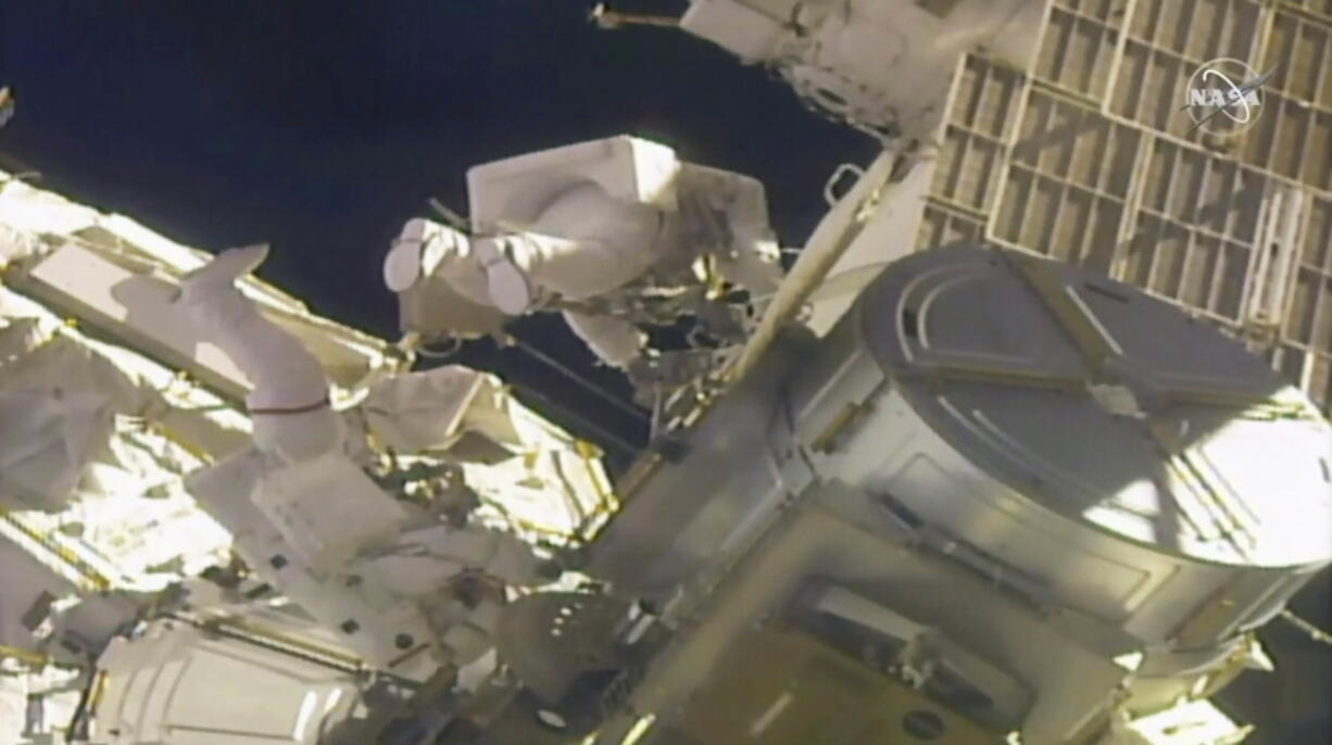 In this image taken from NASA video, NASA astronauts Mike Hopkins, left, and Victor Glover work outside the International Space Station on Monday, Feb. 1, 2021. The pair ventured out on their second spacewalk in under a week Monday to complete a four-year effort to modernize the International Space Station&#039;s power grid.