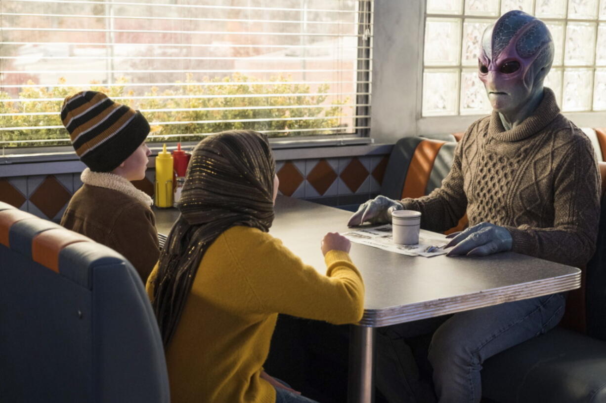 This image released by SYFY shows Judah Prehn, from left, Gracelyn Awad Rinke and Alien Harry in the new series &quot;Resident Alien.&quot; (James Dittinger/SYFY via AP) (SYFY)