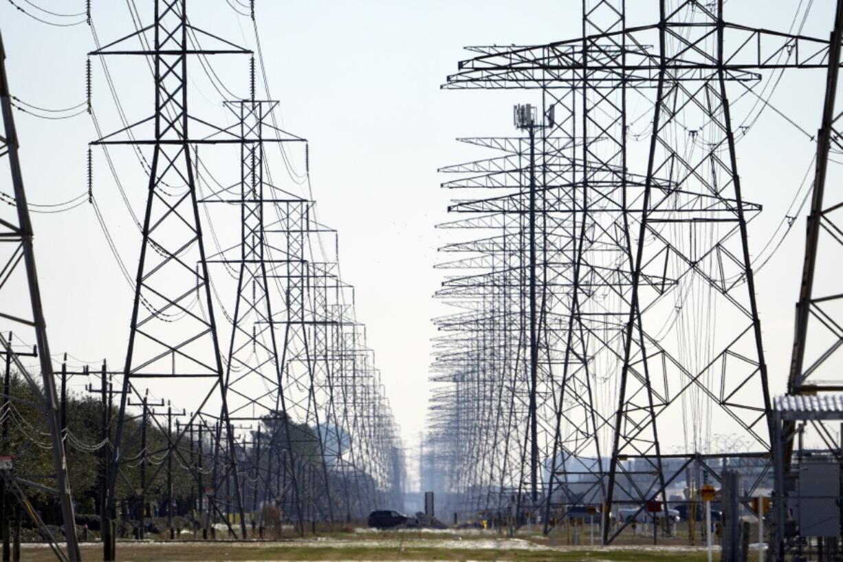 FILE - This Tuesday, Feb. 16, 2021, file photo shows power lines in Houston. When an unusually heavy winter storm blanketed much of Texas with snow, knocking out electricity to millions of homes and leaving many struggling to find clean water, one sector of the population was particularly vulnerable: inmates in Houston at the state&#039;s largest county jail. (AP Photo/David J.