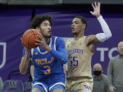 UCLA guard Johnny Juzang, left, looks to shoot around the defense of Washington guard Quade Green (55) during the second half of an NCAA college basketball game, Saturday, Feb. 13, 2021, in Seattle. (AP Photo/Ted S.