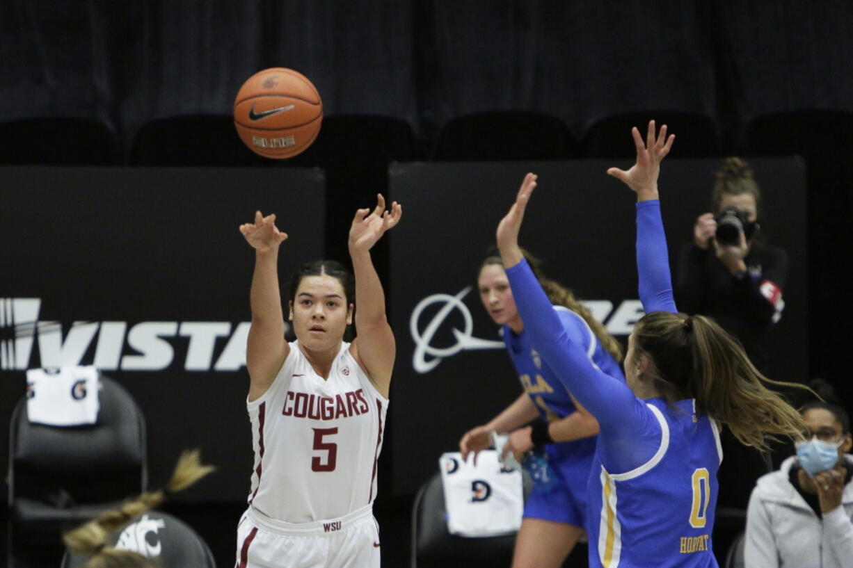 Washington State guard Charlisse Leger-Walker (5) shoots next to UCLA guard Chantel Horvat (0) during the first half of an NCAA college basketball game in Pullman, Wash., Friday, Feb. 5, 2021.