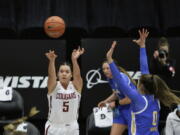 Washington State guard Charlisse Leger-Walker (5) shoots next to UCLA guard Chantel Horvat (0) during the first half of an NCAA college basketball game in Pullman, Wash., Friday, Feb. 5, 2021.