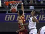 Southern California forward Isaiah Mobley dunks next to Washington forward Hameir Wright during the first half of an NCAA college basketball game Thursday, Feb. 11, 2021, in Seattle. (AP Photo/Ted S.