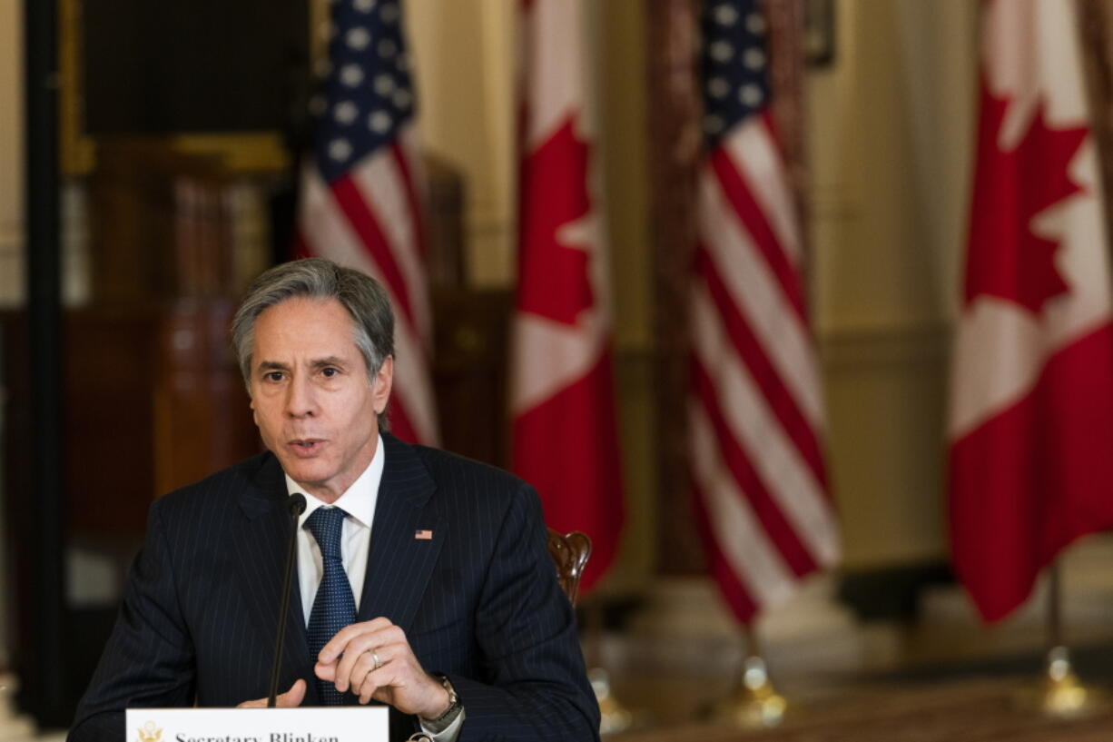 Secretary of State Antony Blinken, second from right, speaks during a virtual meeting at the State Department in Washington, Friday, Feb. 26, 2021, with Canadian Foreign Minister Marc Garneau who is in Ottawa, Canada.