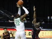 Oregon center Franck Kepnang (22) shoots over Utah center Lahat Thioune (32) during an NCAA college basketball game in Eugene, Ore., Saturday, Feb. 20, 2021.