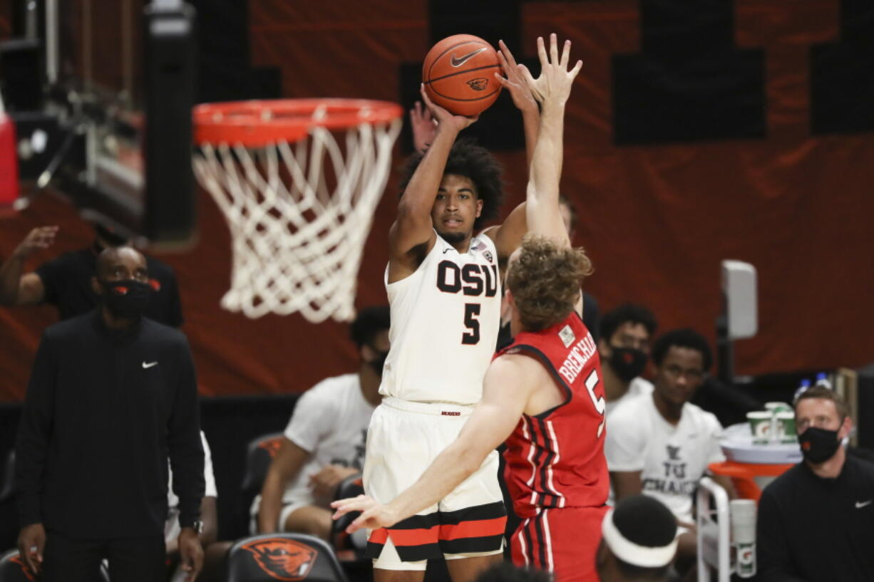 Oregon State&#039;s Ethan Thompson (5) shoots over Utah&#039;s Jaxon Brenchley (5) during the second half of an NCAA college basketball game in Corvallis, Ore., Thursday, Feb. 18, 2021.