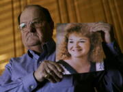 Mortuary owner Brian Simmons holds a photo of his daughter Rhonda Ketchum who died before Christmas of COVID-19, Thursday, Jan. 28, 2021, in Springfield, Mo. Simmons has been making more trips to homes to pick up bodies to be cremated and embalmed since the pandemic hit. For many families, home is a better setting than the terrifying scenario of saying farewell to loved ones behind glass or during video calls amid the coronavirus pandemic.