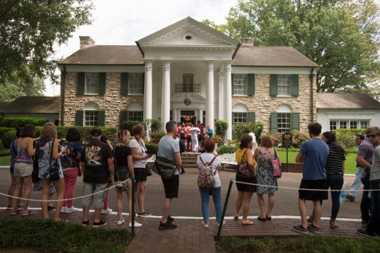 FILE - In an Aug. 15, 2017 file photo, fans wait in line outside Graceland, Elvis Presley&#039;s Memphis home, in Memphis, Tenn. Elvis Presley&#039;s Graceland says it will reopen Thursday, May 21, 2020 after it shut down tours and exhibits due to the new coronavirus outbreak. The tourist attraction in Memphis, Tennessee, said Sunday that it has adjusted its tours, and restaurant and retail operations, since it closed in March.