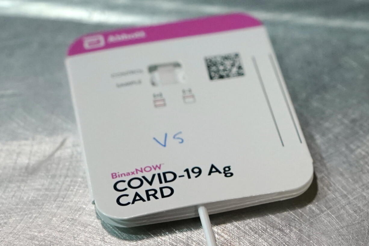 FILE - This Wednesday, Feb. 3, 2021 file photo shows a BinaxNOW rapid COVID-19 test made by Abbott Laboratories, in Tacoma, Wash. After a year of struggling to boost testing, communities across the country are seeing plummeting demand for the service, in some cases shuttering testing sites or even trying to return supplies. (AP Photo/Ted S.