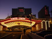 A man walks in front of the Circus Circus hotel and casino in Las Vegas, Feb. 4, 2021. The toll of the coronavirus is reshaping Las Vegas almost a year after the pandemic took hold. The tourist destination known for bright lights, big crowds, indulgent meals and headline shows is a much quieter place these days.