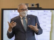 Washington Gov. Jay Inslee speaks with sixth graders in teacher Michelle Dyer&#039;s class during a visit to Firgrove Elementary School in Puyallup, Wash., Thursday, Feb. 18, 2021. Students are back in school and all teachers and students are wearing masks. (Ellen M.