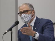 Inslee speaks with administrators and teachers in a question and answer session after visiting two classrooms at Firgrove Elementary School in Puyallup, Wash., Thursday, Feb. 18, 2021. Students are back in school and all teachers and students are wearing masks. (Ellen M.