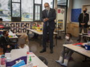 Washington Gov. Jay Inslee speaks with kindergartners in Chelsea Singh&#039;s class during a visit to Firgrove Elementary School in Puyallup, Wash., Thursday, Feb. 18, 2021. Students are back in school and all teachers and students are wearing masks. (Ellen M.