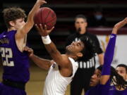 Arizona State guard Remy Martin (1) drives between Washington guard Cole Bajema (22) and forward Hameir Wright during the first half of an NCAA college basketball game, Thursday, Feb. 25, 2021, in Tempe, Ariz.