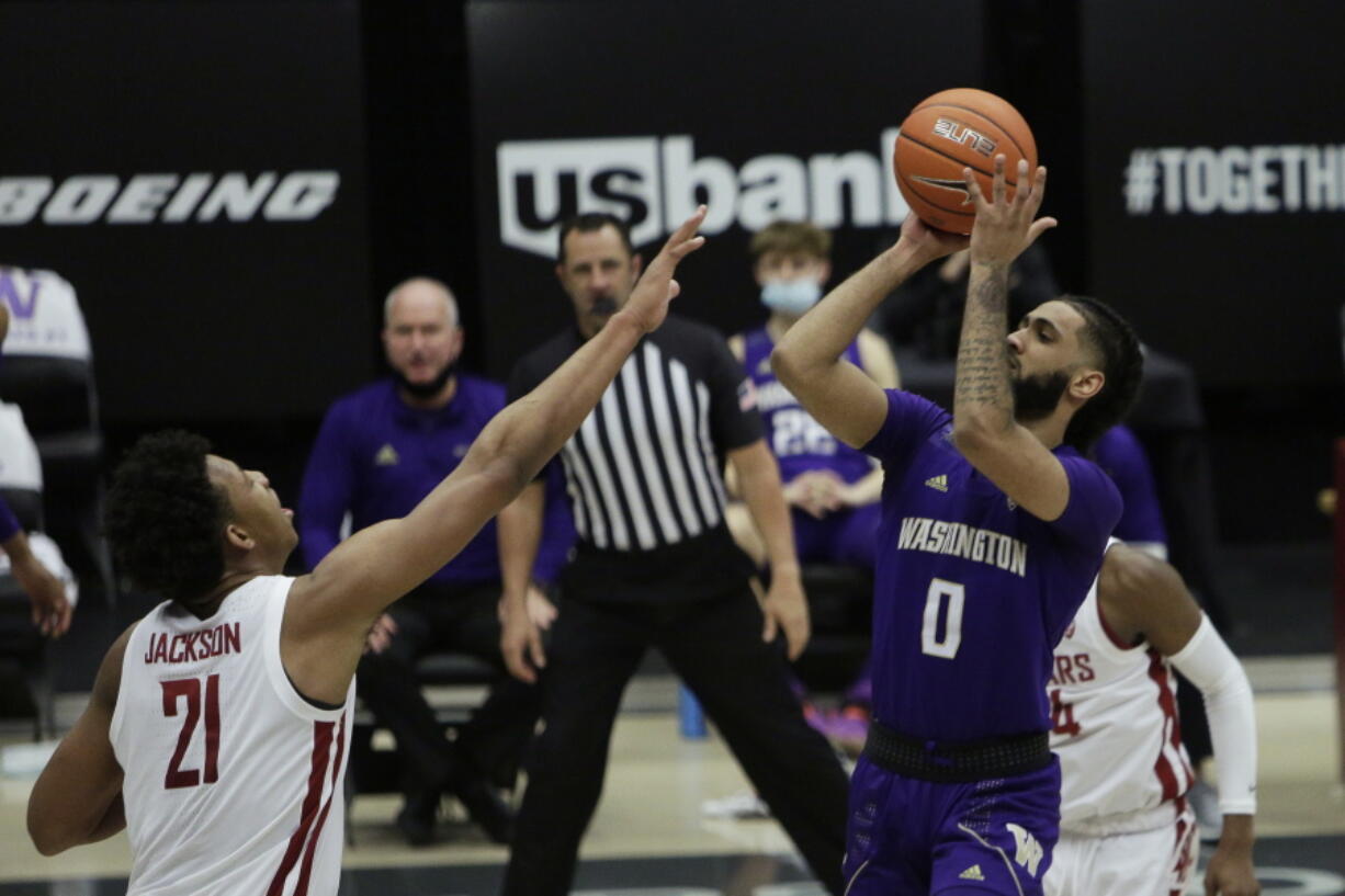 Washington guard Marcus Tsohonis (0) shoots over Washington State center Dishon Jackson (21) during the second half of an NCAA college basketball game in Pullman, Wash., Monday, Feb. 15, 2021.