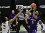 Washington guard Marcus Tsohonis (0) shoots over Washington State center Dishon Jackson (21) during the second half of an NCAA college basketball game in Pullman, Wash., Monday, Feb. 15, 2021.