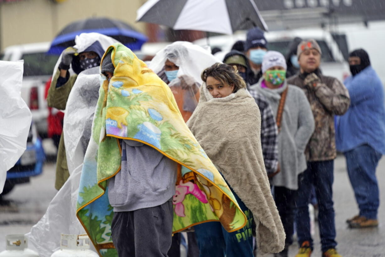 People wait in line to fill propane tanks Wednesday, Feb. 17, 2021, in Houston. Customers waited over an hour in the freezing rain to fill their tanks. Millions in Texas still had no power after a historic snowfall and single-digit temperatures created a surge of demand for electricity to warm up homes unaccustomed to such extreme lows, buckling the state&#039;s power grid and causing widespread blackouts. (AP Photo/David J.