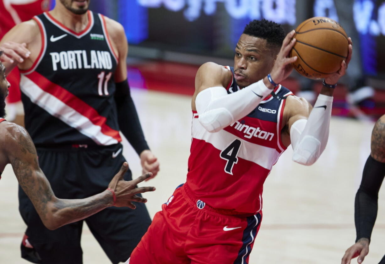 Washington Wizards guard Russell Westbrook looks to pass the ball during the first half of the team&#039;s NBA basketball game against the Portland Trail Blazers in Portland, Ore., Saturday, Feb. 20, 2021.