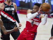 Washington Wizards guard Russell Westbrook looks to pass the ball during the first half of the team&#039;s NBA basketball game against the Portland Trail Blazers in Portland, Ore., Saturday, Feb. 20, 2021.