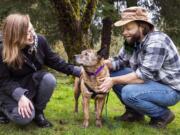 Chloe Wheeler, left, and Jon-Erik Hegstad love on their dog, Shirley, in their backyard on Feb. 5. The Longview couple recently reunited with Shirley after she went missing 15 months ago.