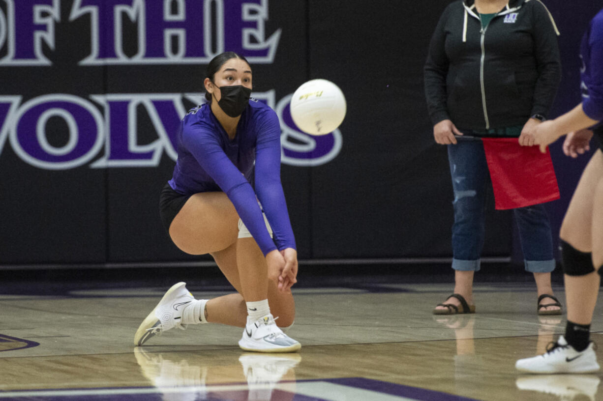 Heritage senior Katie Peneueta (left) makes a play on the ball during a match against Prairie at Heritage High School on Feb.