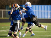 Ridgefield senior Tanner Roberts tries to swat away a pass attempt during a practice on Wednesday, March 3, 2021, at Ridgefield High School. Playing his fifth position in three years, Roberts continues to show his instincts and leadership are key to his football success.