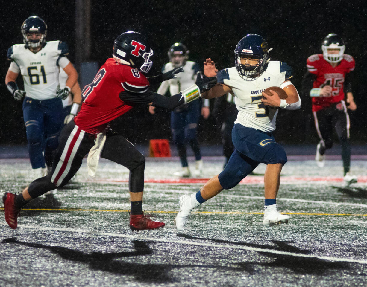 Seton Catholic's Elijah Volk tries to elude the tackle of a Tenino defender (Eric Trent/Centralia Chronicle)