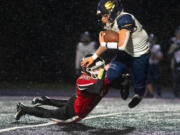 Seton Catholic's Jack Callerme gets hit by Tenino's Randall Marti during Thursday's game in Tenino (Eric Trent/Centralia Chronicle)