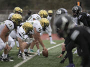 Evergreen players face off against Heritage defenders in the second quarter at McKenzie Stadium on Friday afternoon, March 5, 2021.