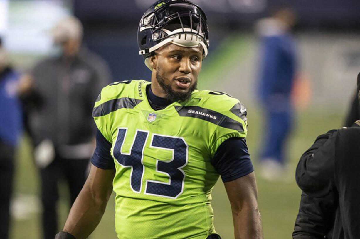 Seattle Seahawks defensive end Carlos Dunlap comes off the field after sealing ThursdayIs 28-21 win over the Arizona Cardinals.