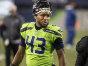 Seattle Seahawks defensive end Carlos Dunlap comes off the field after sealing ThursdayIs 28-21 win over the Arizona Cardinals.