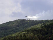 FILE - In this July 10, 2020, file image taken from video provided by Russian Emergency Ministry, a multipurpose amphibious aircraft releases water to extinguish a fire in the Trans-Baikal National Park in Buryatia, southern Siberia, Russia. The National Oceanic and Atmospheric AdministrationCfUs annual Arctic Report Card, released on Tuesday, Dec. 8, 2020, shows how warming temperatures in the Arctic are transforming the region&#039;s geography and ecosystems.