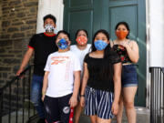 Carmela Apolonio Hernandez, center, is pictured with her four children on the steps of the Germantown Mennonite Church in Pennsylvania, where the family has lived in sanctuary to avoid deportation.