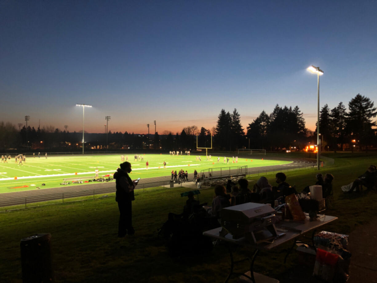 Football fans gather on the berm near the field before Hudson&#039;s Bay&#039;s game against R.A. Long on Friday. It was the first varsity football game held on the campus of the school, which opened in 1955.