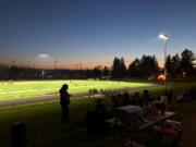 Football fans gather on the berm near the field before Hudson&#039;s Bay&#039;s game against R.A. Long on Friday. It was the first varsity football game held on the campus of the school, which opened in 1955.