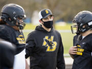 Hudson&#039;s Bay football coach Ray Lions talks to linemen Laufilitonga &#039;Junior&#039; Tamoua and Levi Mikaele at a recent practice. The Eagles have formed a unique bond through their shared experiences, and coach Ray Lions has embraced and cultivated the family-like atmosphere.