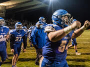 The La Center sideline reacts to their win over Castle Rock during a game at La Center High School on Friday night, March 19, 2021 (Nathan Howard for The Columbian)