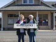 Postmasters Kathy Olson left and Gretchen Goodson holds the Nahcotta Post sign taken down from the building behind them that has been the Post Office for 132 years.  Nahcotta on the Long Beach peninsula population 125 lost its Post Office after USPS didn&#039;t renew its lease on the newly purchased property.