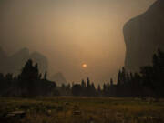 Thick smoke from multiple forest fires shrouds iconic El Capitan, right, and the granite walls of Yosemite Valley on Sept. 12 in Yosemite National Park, Calif.