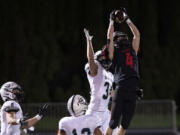 Camas's Andrew Caroussos outleaps Skyview's Brenner Tobiasson for a 35-yard fourth-down completion in the fourth quarter of the Papermakers' 38-31 victory on last season at Doc Harris Stadium. The catch set up Camas&#039; game-tying field goal when time expired.