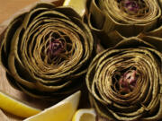 Artichokes steam in a lemon-scented bath until tender. (E.